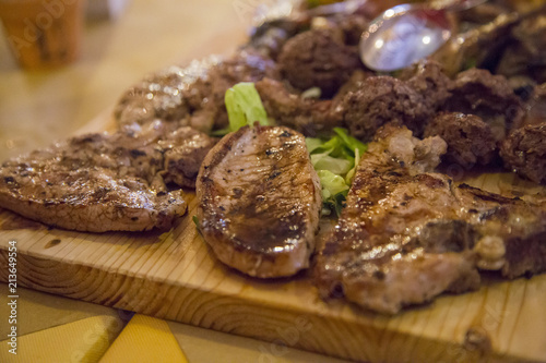 image of various types of grilled meat presented on a wooden chopping board