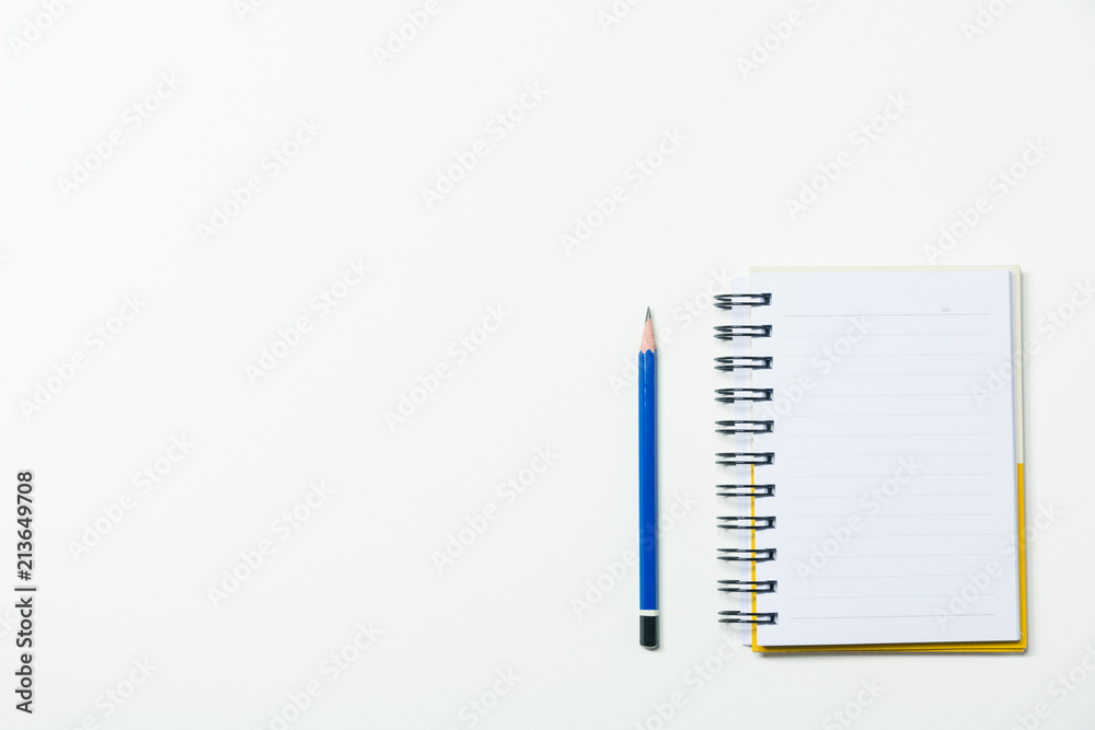 Top view of pencil and notebook isolated on white background and copy space for insert text. Top view of pencil and notebook isolated on white background and copy space for insert text.