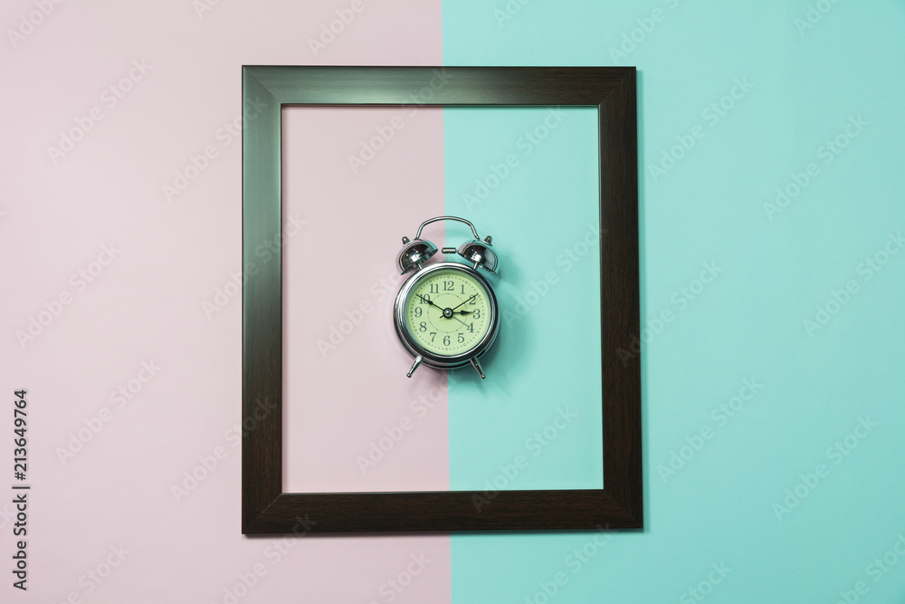 Top view of alarm clock in middle of frame on colorful background and copy space for insert text. Top view of alarm clock in middle of frame on colorful background and copy space for insert text.