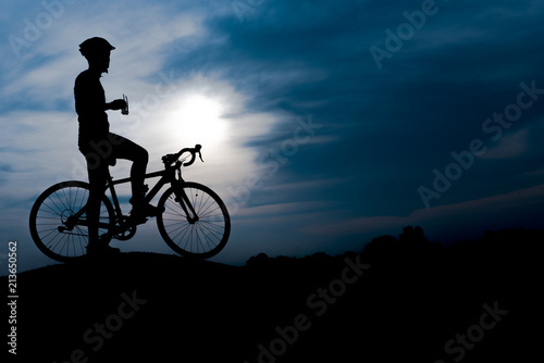 Silhouette of the cyclist riding a road bike at sunset.Mountain bicycle and man.Life style outdoor © srijaroen