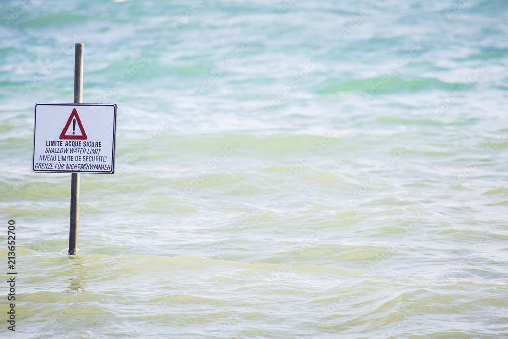 image of generic danger signal  shallow water limit signpost at sea.