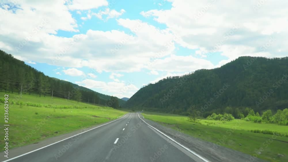 Beautiful mountain road. Movement of the camera. Blue sky and clouds. Beautiful mountain road. Movement of the camera. Blue sky and clouds.