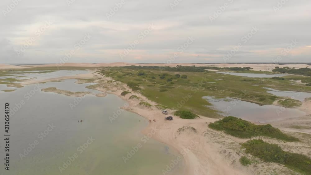 Aerial view of cars and vegetation near dunes and lagoons in Jericoacoara, Brazil Aerial view of cars and vegetation near dunes and lagoons in Jericoacoara, Brazil