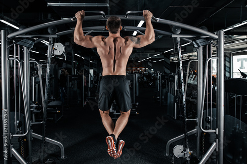 Strong man doing pull ups photo
