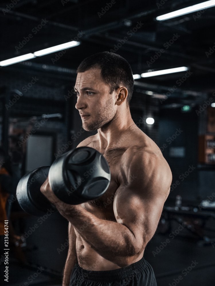 Muscular man working out in gym