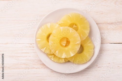 Top view of canned pineapple slices on plate