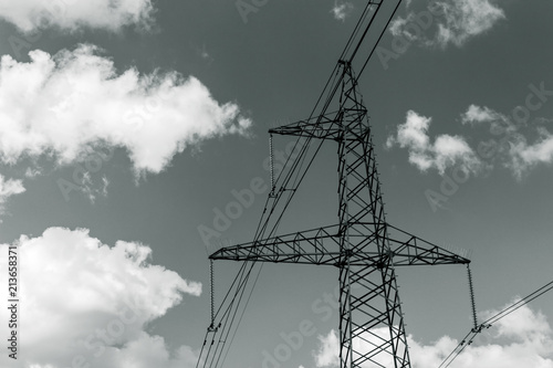 Power pylons and high-voltage lines against the background of the cloudy sky, power lines.
