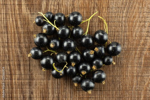 Fresh Raw Black Currant berry on brown wood photo