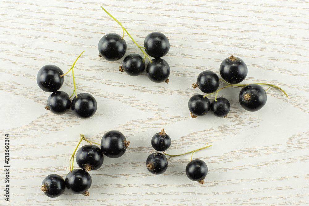 Fresh Raw Black Currant berry on grey wood Fresh Raw Black Currant berry on grey wood