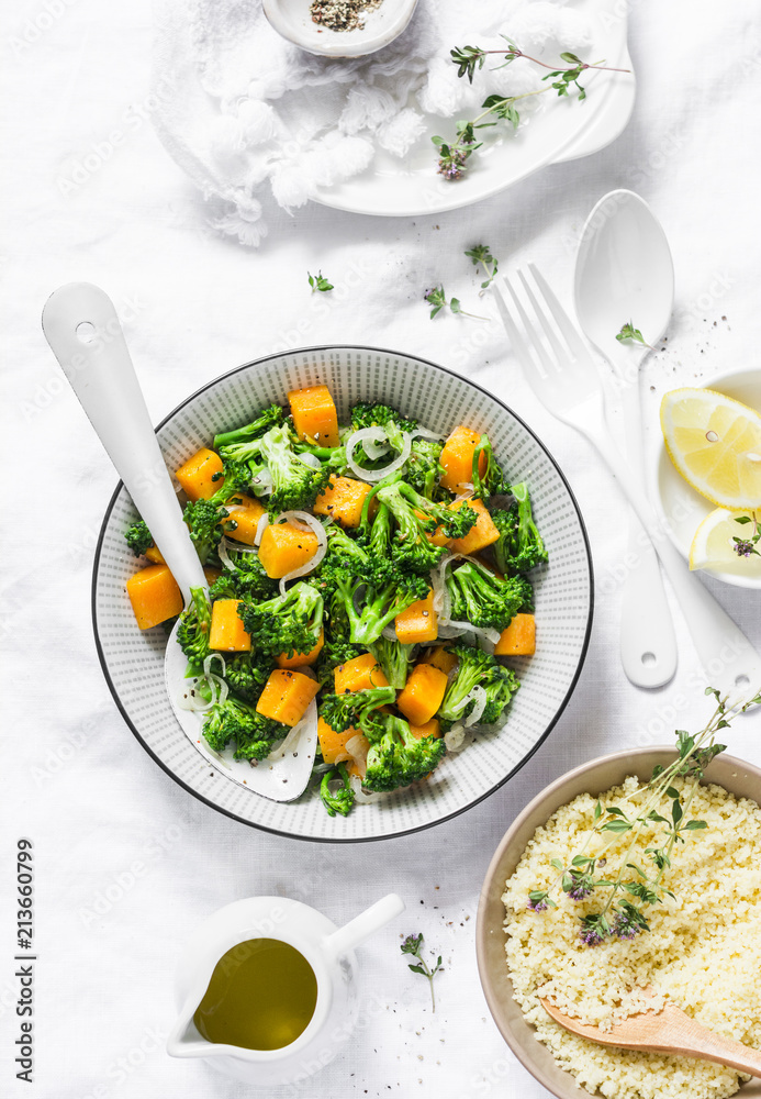 Broccoli, pumpkin warm salad with couscous on a light background, top view. Vegetarian food concept, healthy diet lifestyle. Flat lay