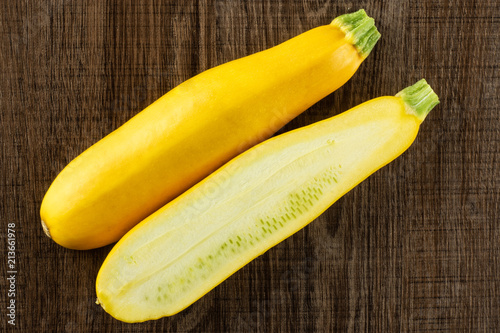 Fresh Raw yellow zucchini on brown wood