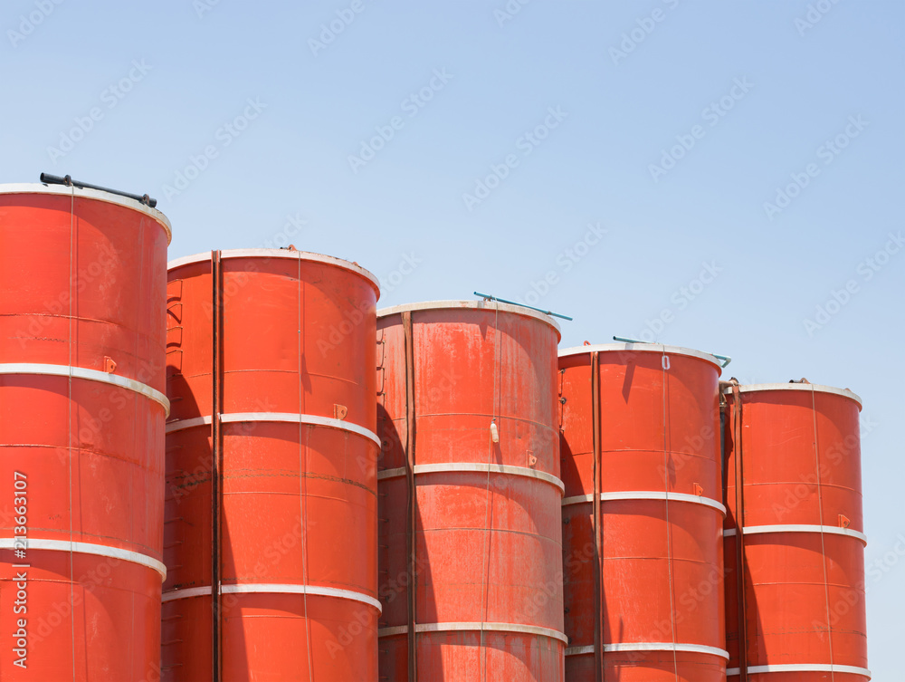 Concrete mixing silo, orange steel silo against blue sky. Concrete mixing silo, orange steel silo against blue sky.
