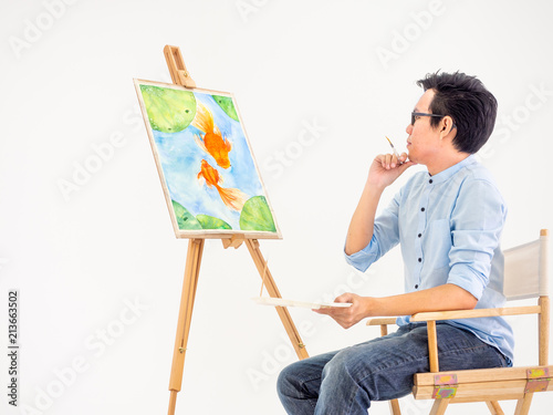 man drawing fish by watercolor.