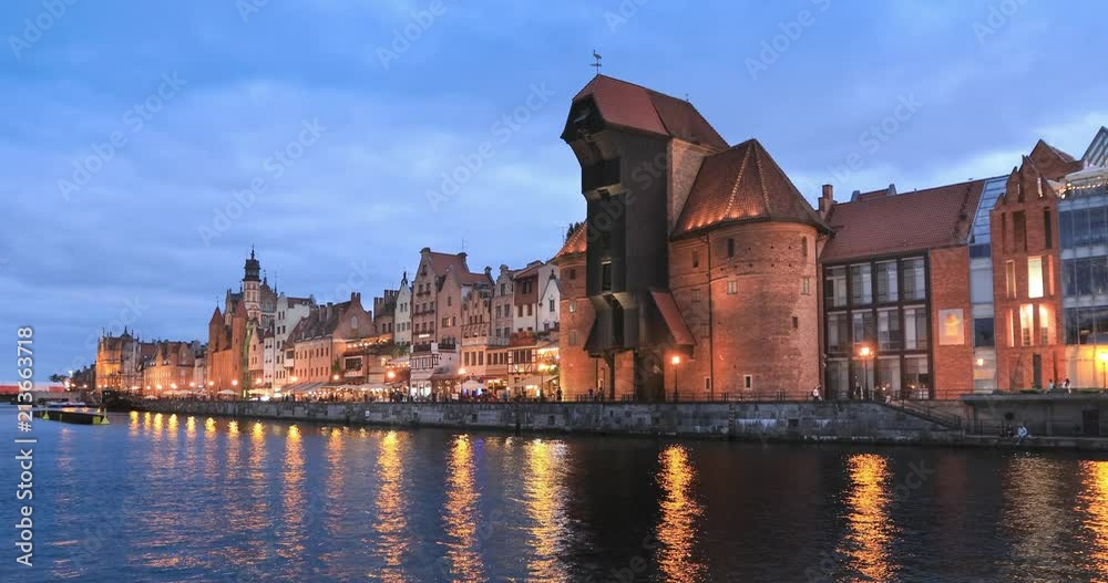 View of embankment of Motlawa river with medieval port crane, called Zuraw at dusk, Gdansk, Poland
