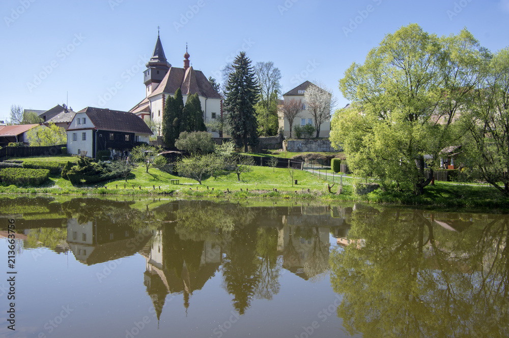 Church of St. Wenceslas in town Svetla nad Sazavou, clock tower, greenery and blue sky, river Sazava