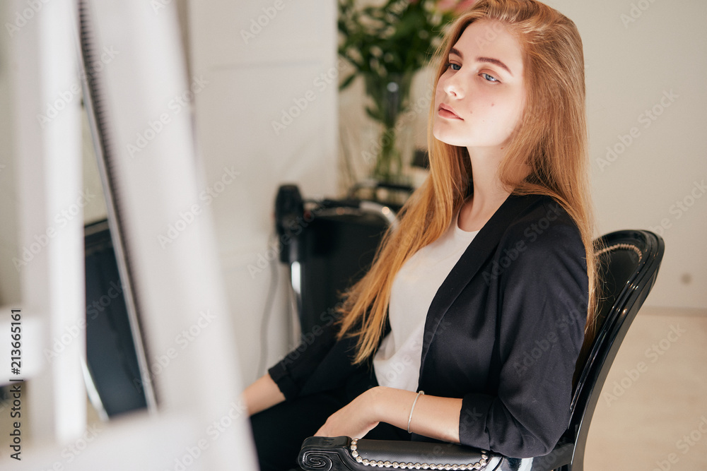 Girl taking care of her hair on hairdresser shop