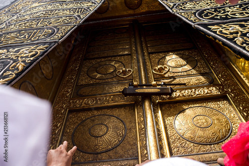 MECCA, SAUDI ARABIA - MAY 01 2018: The golden doors of the Holy Kaaba closeup, covered with Kiswah. Massive lock on the doors. Entrance to the Kaaba in Masjid al Haram