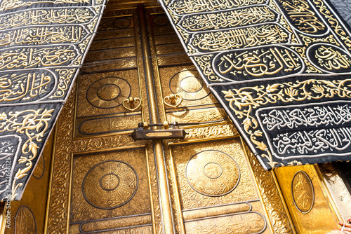MECCA, SAUDI ARABIA - MAY 01 2018: The golden doors of the Holy Kaaba closeup, covered with Kiswah. Massive lock on the doors. Entrance to the Kaaba in Masjid al Haram photo