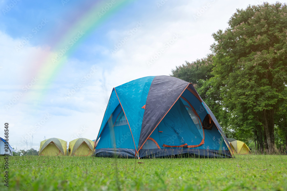 The Colorful Camping Tent with rainbow in the summer at forest. Photos |  Adobe Stock