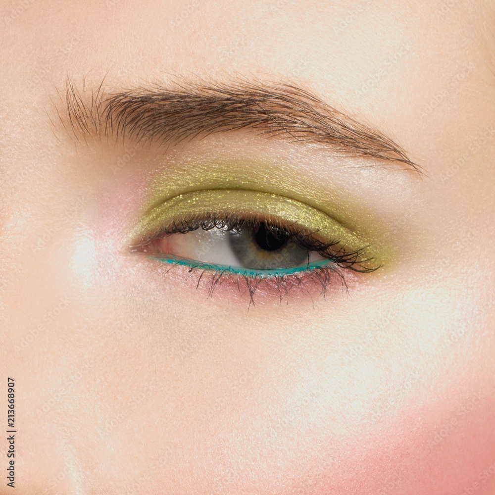 Obraz premium Beautiful blue eyes with bright creative cosmetics. Long eyebrows and dense eyelashes create the fashionable image. Evening cosmetics, cosmetics, cosmetology