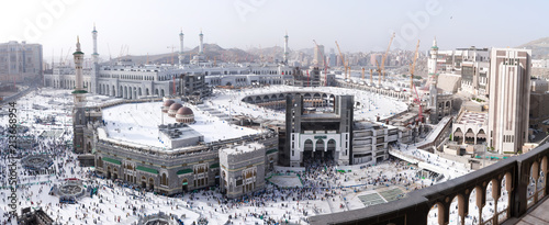 MECCA, SAUDI ARABIA - MAY 02 2018: Outstanding wide panoramic view on entire Masjid Al Haram mosque from Clock Tower Abraj Al Bait. Visible center to horizon, aerial skyline view. Crowd of people down
