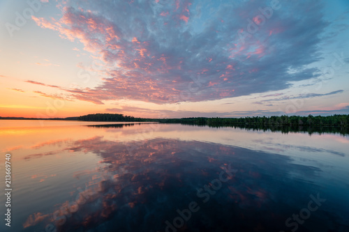 Very beautiful landscape image of a sunset behind calm mirror clear lake photo