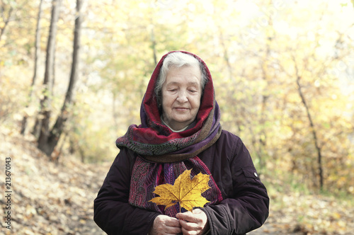 elderly woman on a walk in autumn park