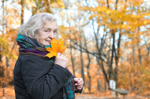 elderly woman on a walk in autumn park