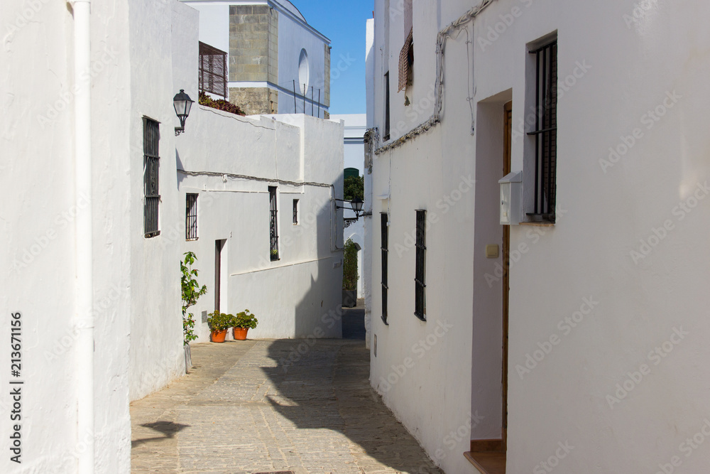 Fototapeta premium Vejer white town typical street on sunny day in Cadiz province, Andalusia. Tour visit, travel destination, summer holidays concepts