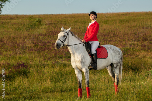The horsewoman on a red horse. Horse riding. Horse racing. Rider on a horse.