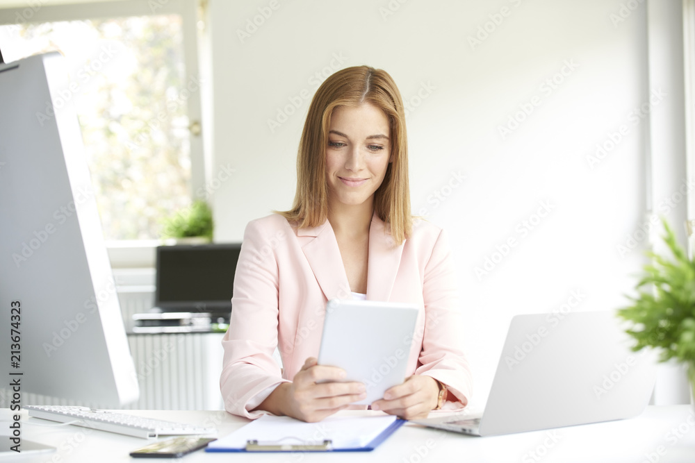 Young businesswoman using digital tablet. Home office Young businesswoman using digital tablet. Home office