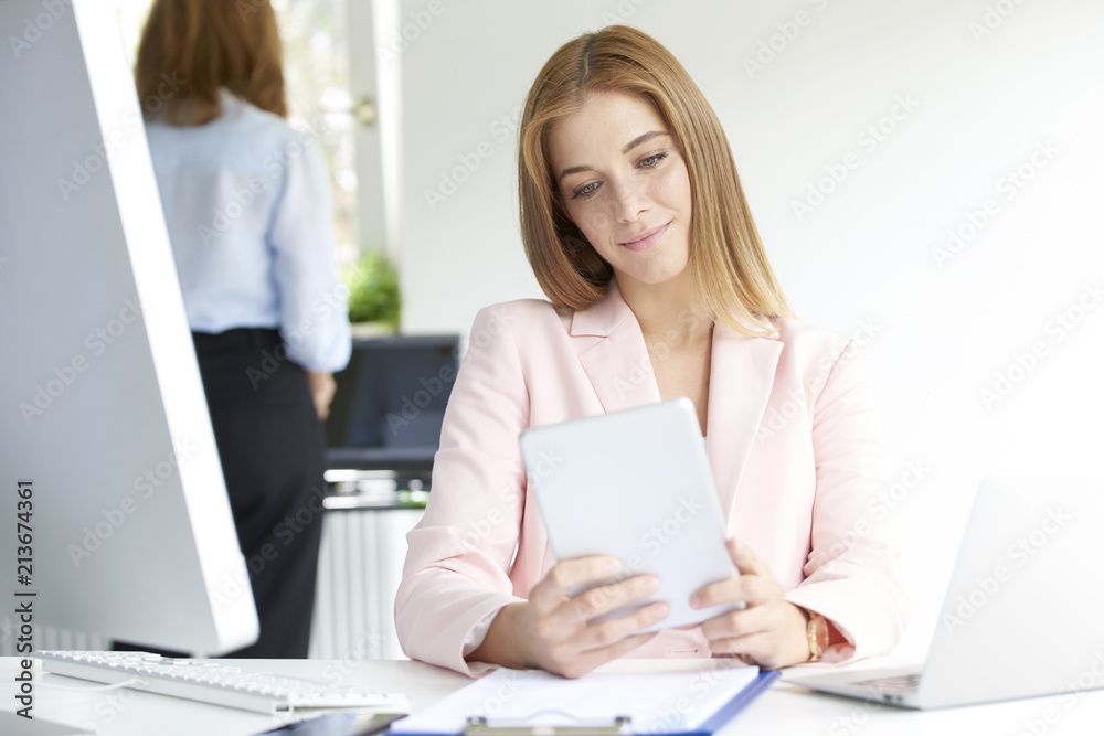 Young businesswoman using digital tablet Young businesswoman using digital tablet