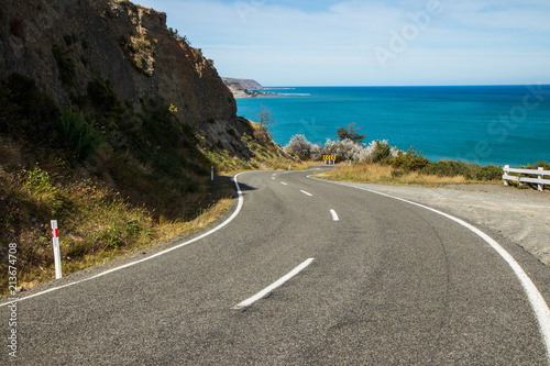 Road leading to a bay. Crystal clear water, amazing landscape. Windy road. Travel, adventure, discover, explore, drive, hike. Sea, ocean, environment, sky.