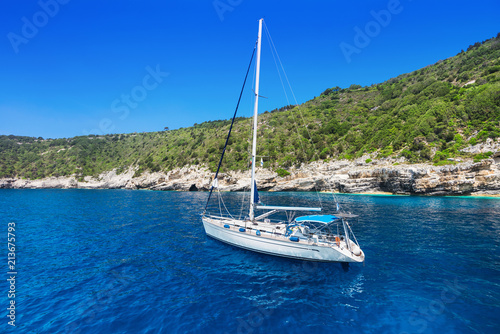 Beautiful bay with sailing boat, Antipaxos island, Greece