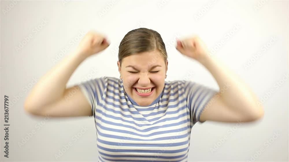 Brunette beautiful young woman, loudly speaking, wow, and smiling at the camera. Brunette beautiful young woman, loudly speaking, wow, and smiling at the camera.