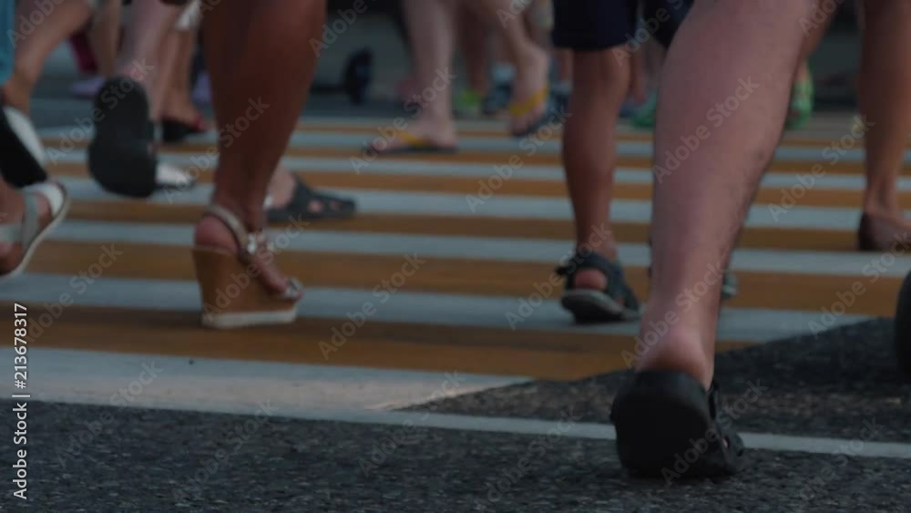 People walk through the zebra crossing. Fast secure highway crossing People walk through the zebra crossing. Fast secure highway crossing