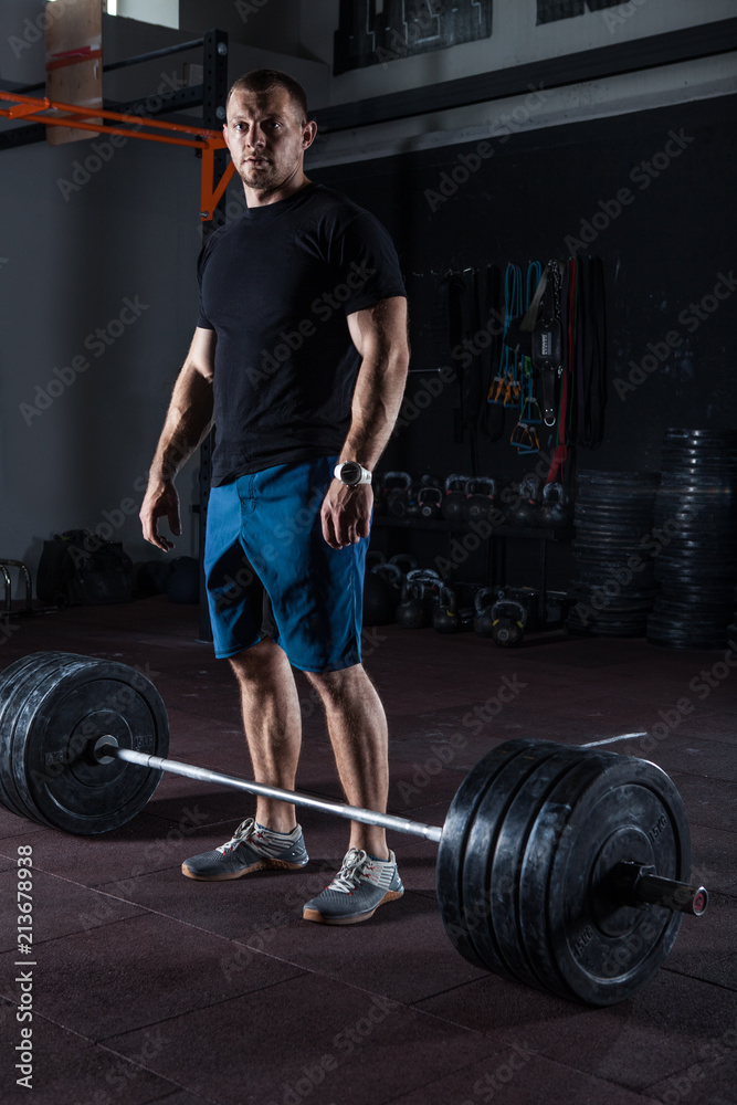 Muscular fitness man posing in gym