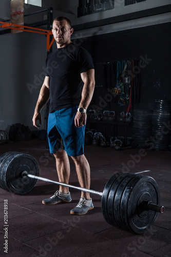 Muscular fitness man posing in gym