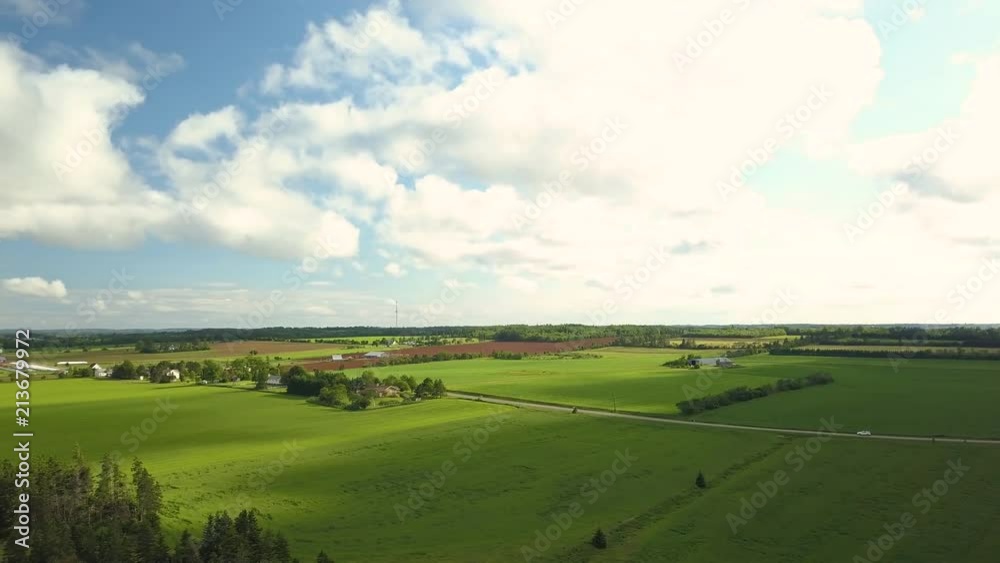 Aerial view of car driving through cloudy Prince Edward Island countryside Aerial view of car driving through cloudy Prince Edward Island countryside