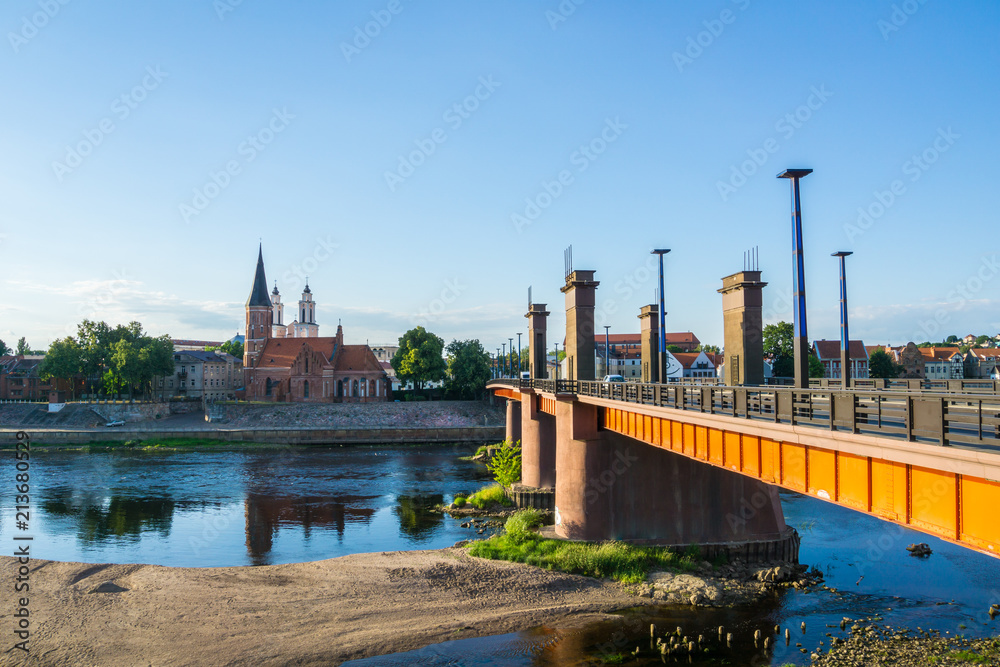 Naklejka premium Lithuania, Vytautas Church and bridge in Kaunas in dawning light