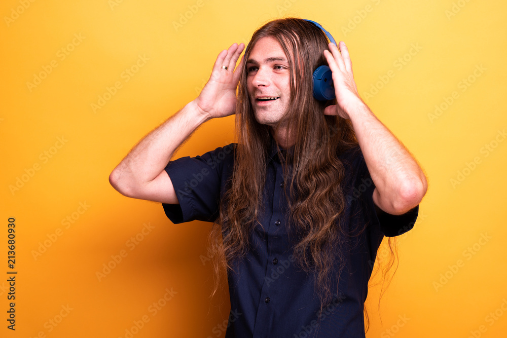 Adult man touching his headphones Adult man touching his headphones