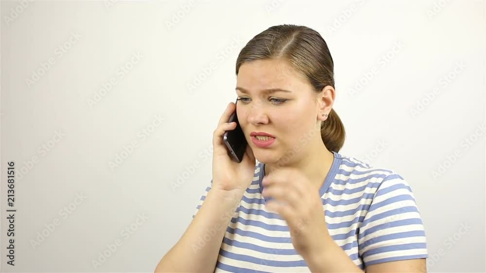 Young beautiful woman talking on the phone. bad news. Young beautiful woman talking on the phone. bad news.