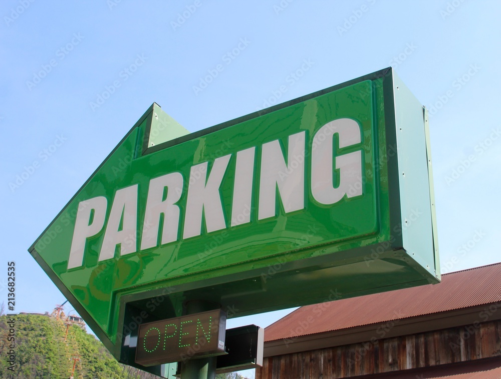 The big green arrow parking sign on a close up view.