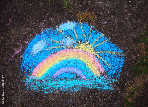 Rainbow of Colored chalk on a sidewalk background, top view.