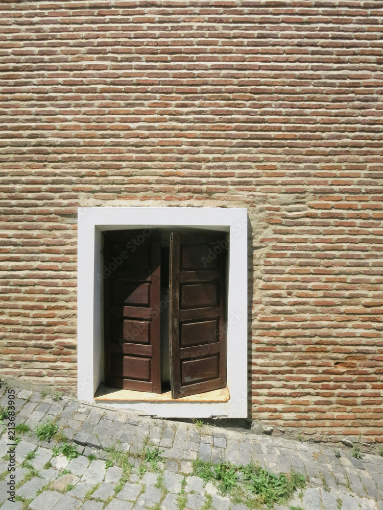 Street wooden front door to the house of red brick