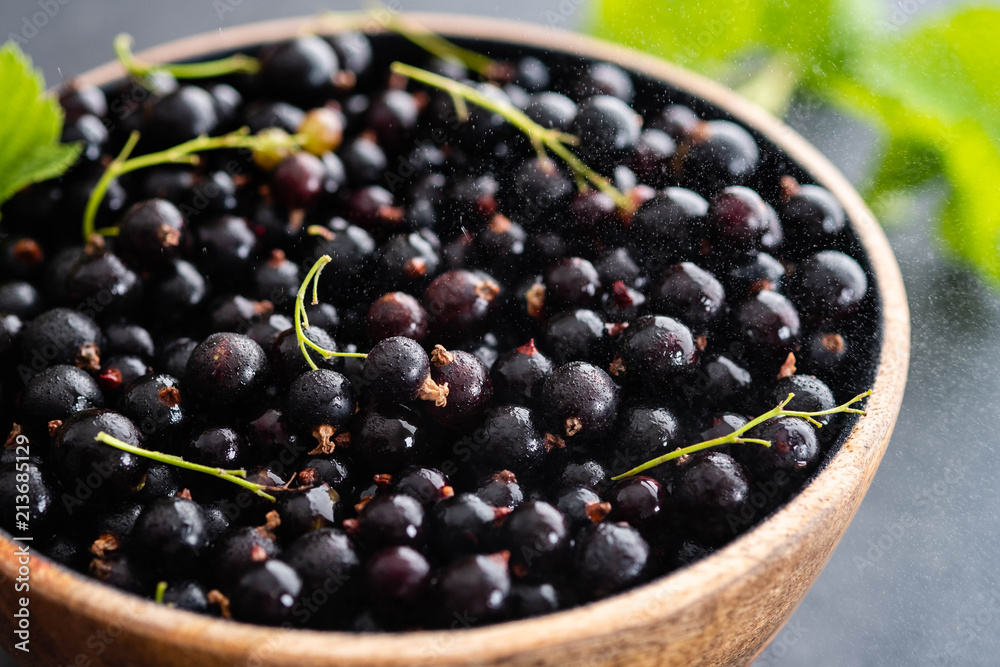 Blackcurrant berries with leaves, blackcurrant in a bowl. Blackcurrant berries with leaves, blackcurrant in a bowl.