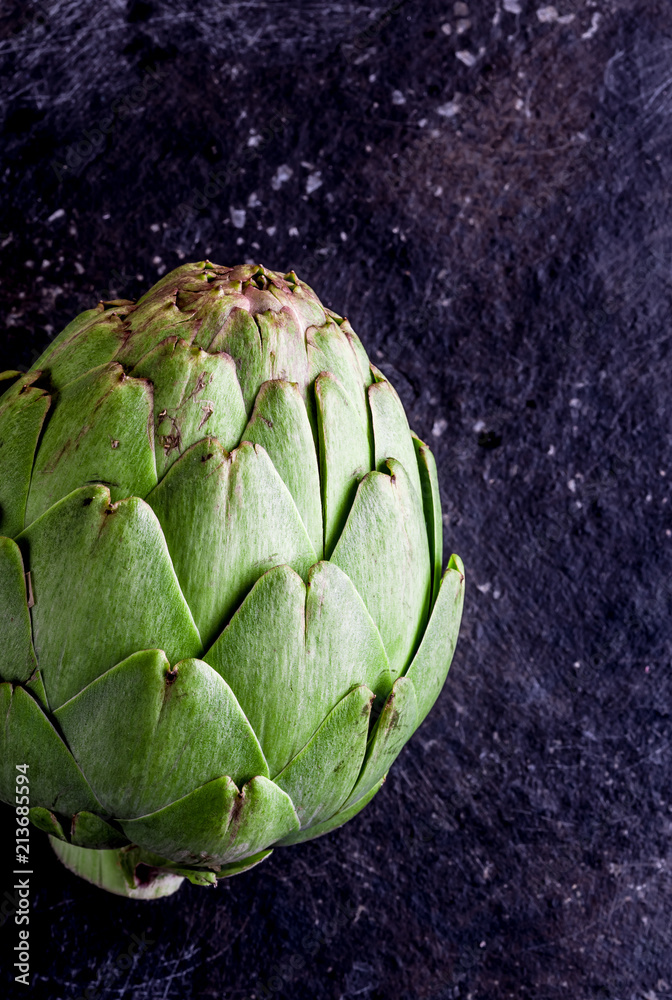 Fototapeta premium ARTICHOKE. Close up of artichoke, top view, dark background. Macro