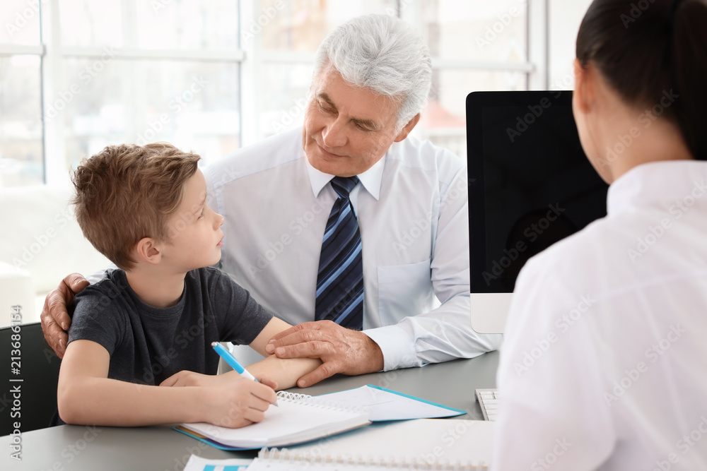 Senior man with his grandson having appointment at child psychologist office Senior man with his grandson having appointment at child psychologist office