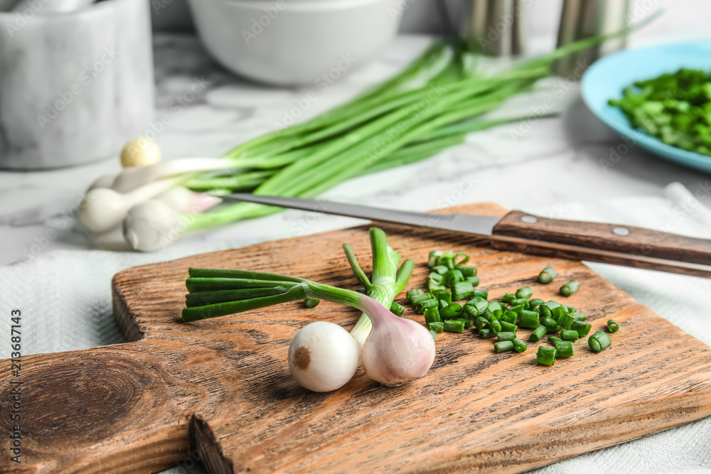 Fresh green onion on wooden board, closeup Fresh green onion on wooden board, closeup
