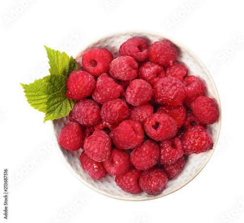 Plate with ripe raspberries on white background, top view